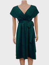 Mannequin displaying a dark green A-line midi dress with a V-neck wrap bodice and a self-tie sash.