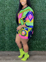 Profile view of a woman in a brightly colored sequined t-shirt dress, showcasing the geometric print and graphic details, with neon yellow ankle boots.