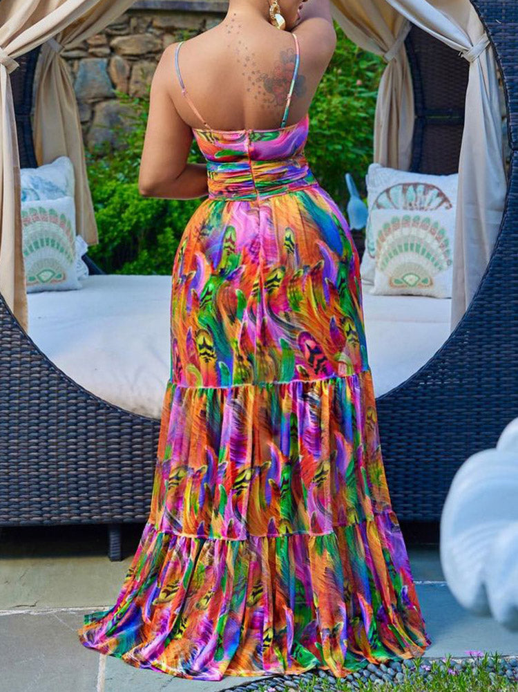 Mannequin displaying a long, colorful abstract print dress with a cut-out and tiered skirt