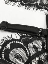 Close-up of the adjustable strap and lace trim on a black dress