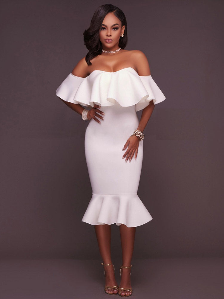 Woman wearing a white off-the-shoulder ruffle dress and gold heels, front view