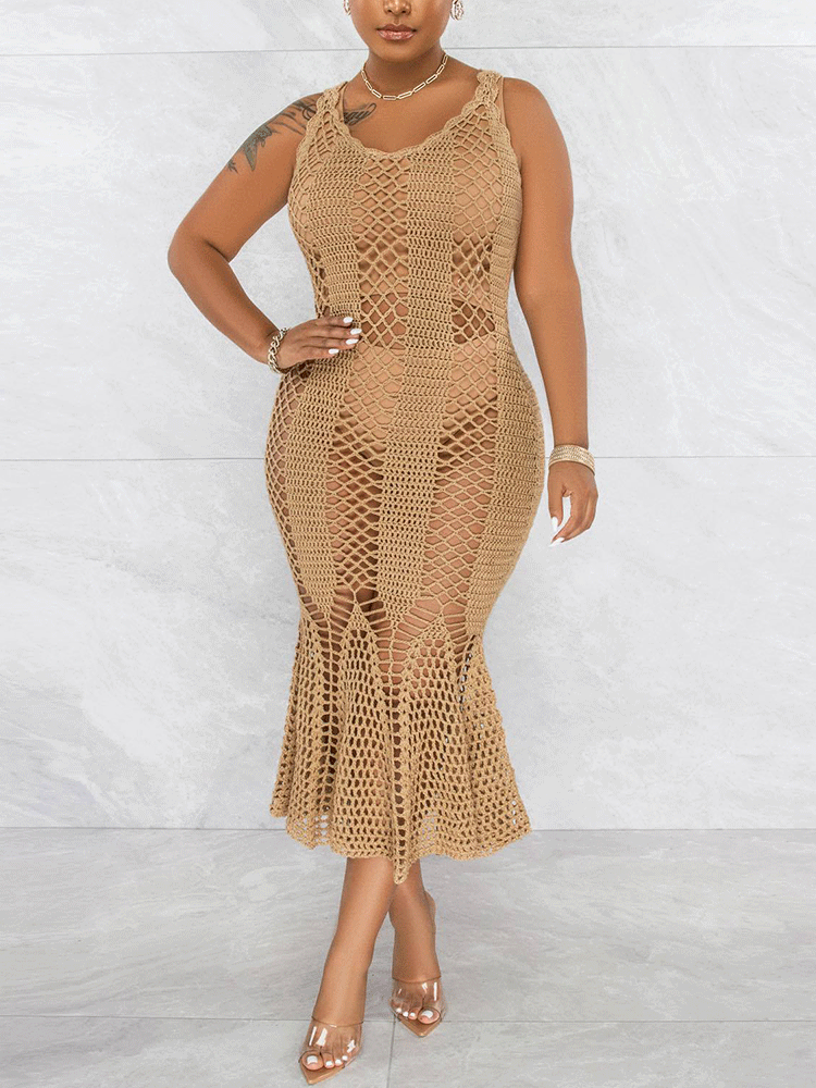 Woman wearing a tan sleeveless crochet knit mermaid dress with a scoop neck.