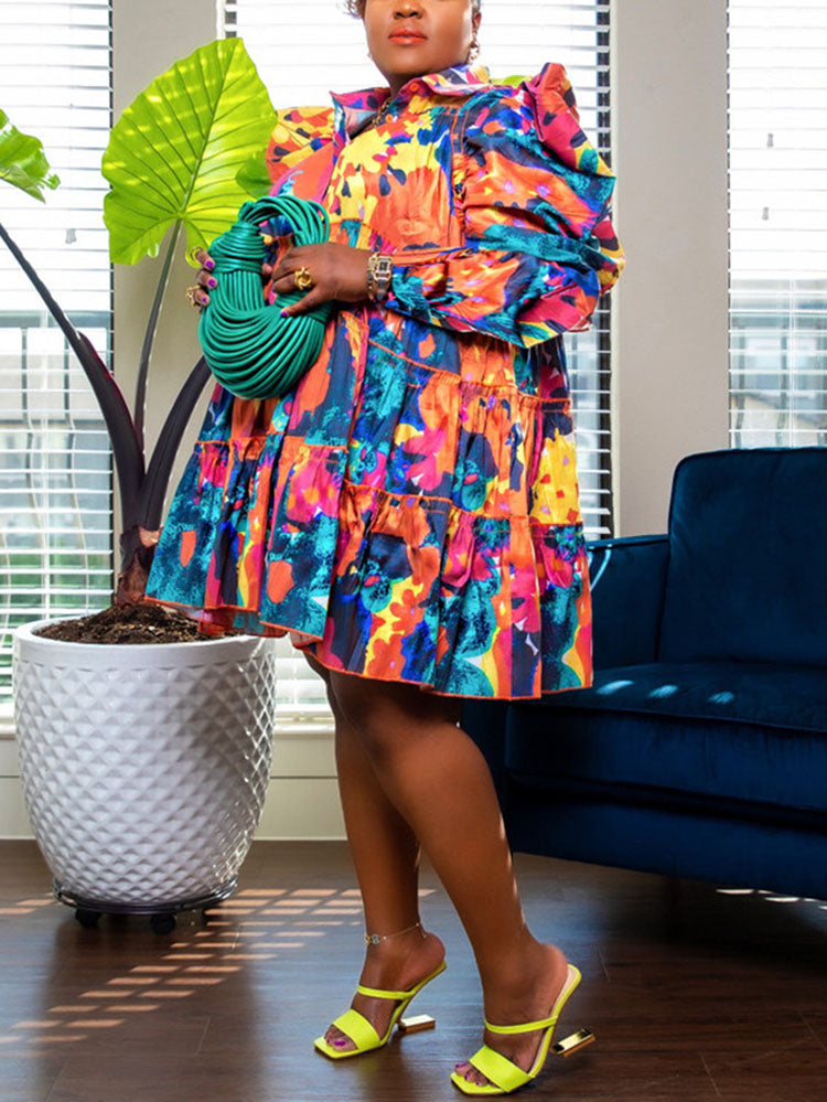 Woman in a multi-colored floral print mini dress with voluminous puffed sleeves and a tiered design.