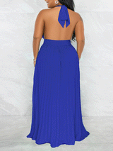 Woman wearing a royal blue halter neck maxi dress with a keyhole cutout and pleated skirt, back view.