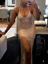 Front view of a woman in a champagne sequined dress, showcasing the v-neckline and high slit.