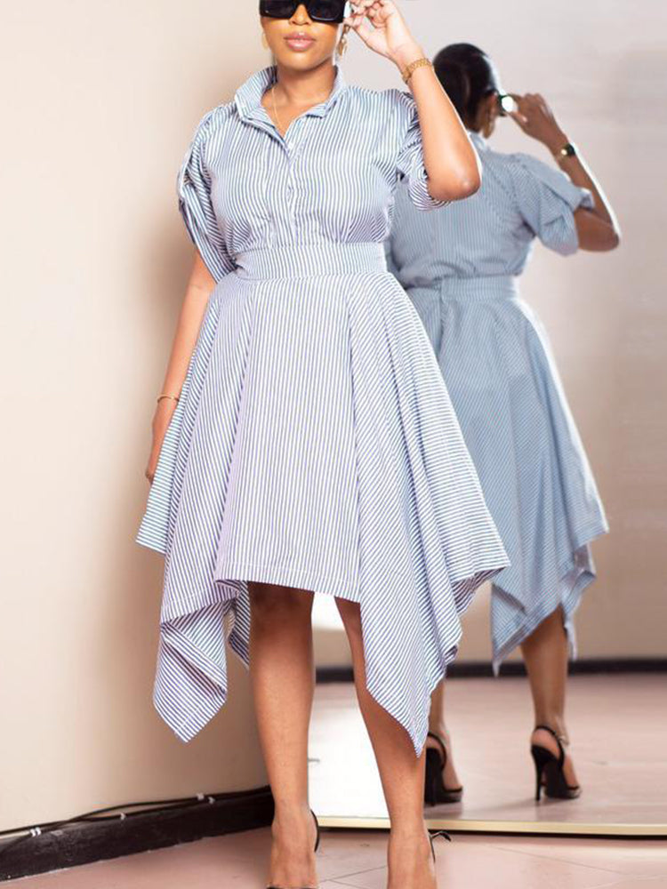 Woman adjusting her sunglasses while wearing a blue and white striped shirt dress.