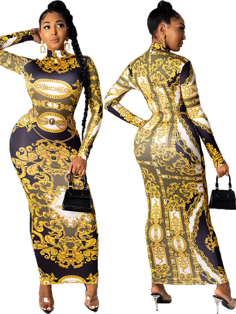 Front view of a woman in a long-sleeved, baroque-print maxi dress with a high neckline and a belted waist.