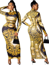 Front view of a woman in a long-sleeved, baroque-print maxi dress with a high neckline and a belted waist.