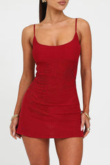Close-up front view of the red embellished mini dress, highlighting the fabric texture and embellishments.