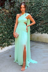 woman in a mint green one-shoulder pleated gown with a high slit and cut-out detail