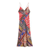 A colorful patchwork print maxi dress with spaghetti straps, shown flat, from a different angle.