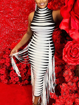 Close-up of a woman in a black and white striped knit dress with fringe, showcasing the texture and design.
