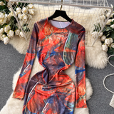 Close-up of the top of the long-sleeved abstract print maxi dress, showing the round neckline and vibrant pattern.