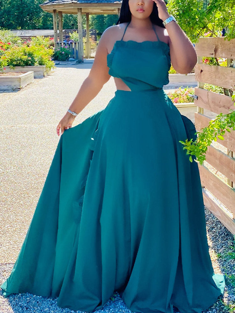 Woman wearing a teal two-piece maxi dress with a halter neckline and ruffled trim, standing outdoors.