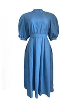 Front view of a blue denim midi dress with puffed sleeves and a pleated skirt, displayed on a white background.