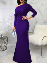 front view of a woman wearing a purple one-shoulder draped long sleeve mermaid formal gown