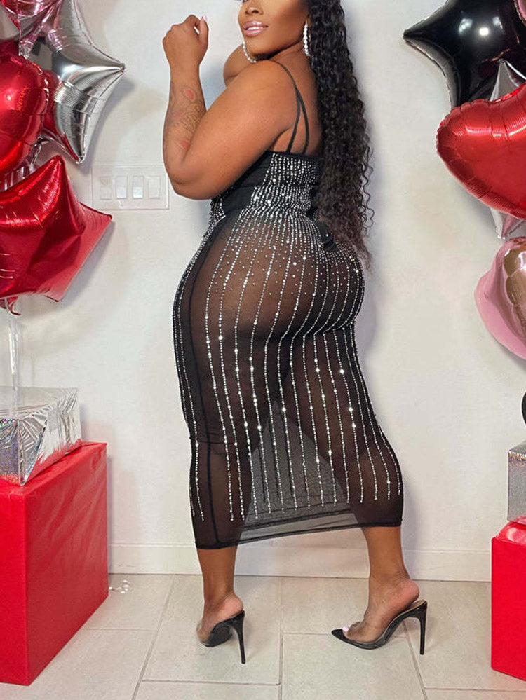 back view of a woman in a black embellished sheer midi dress