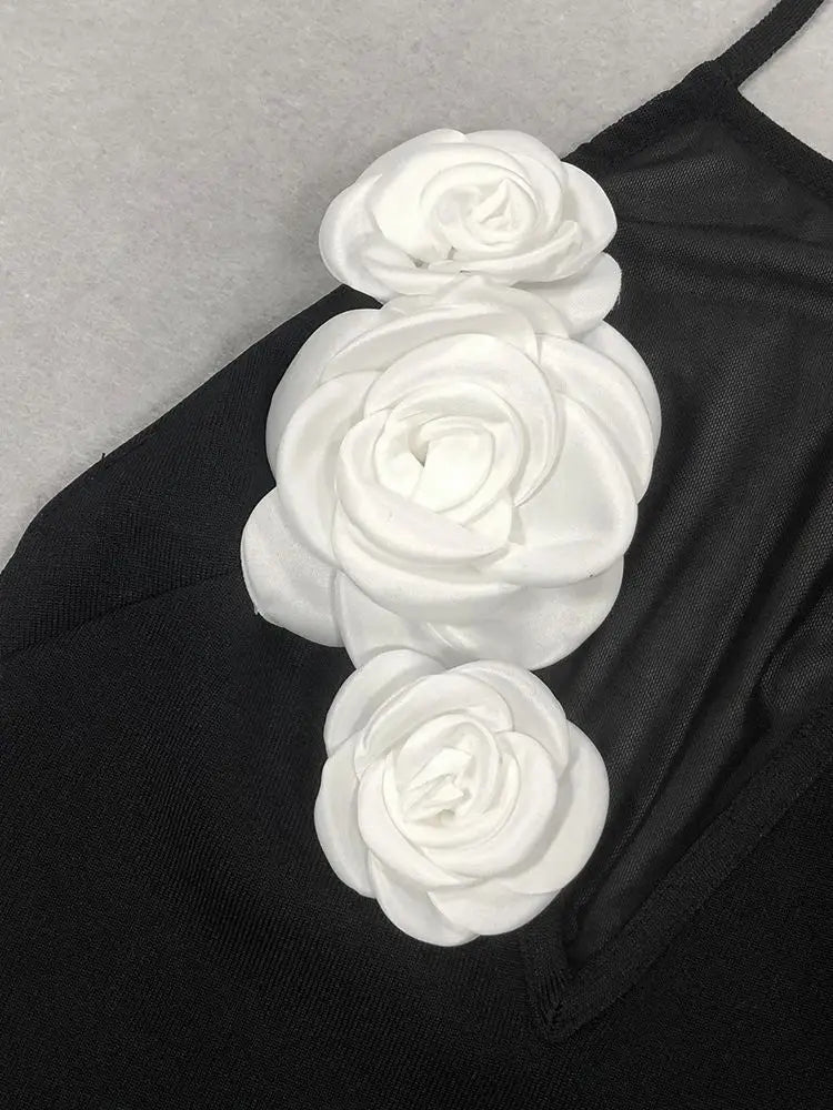 close-up of white floral embellishments on the bodice of a black halter dress