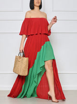 Woman wearing a red and green colorblock maxi dress with an off-the-shoulder neckline.