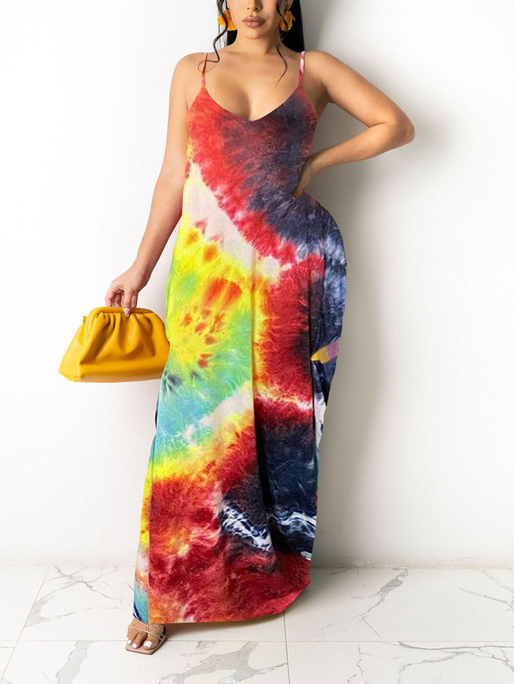 Woman wearing a colorful tie-dye print maxi dress with spaghetti straps and a V-neckline, holding a yellow clutch.