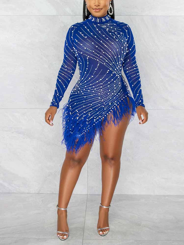 Woman wearing a royal blue sheer mesh mini dress with long sleeves, rhinestone embellishments, and feather trim.