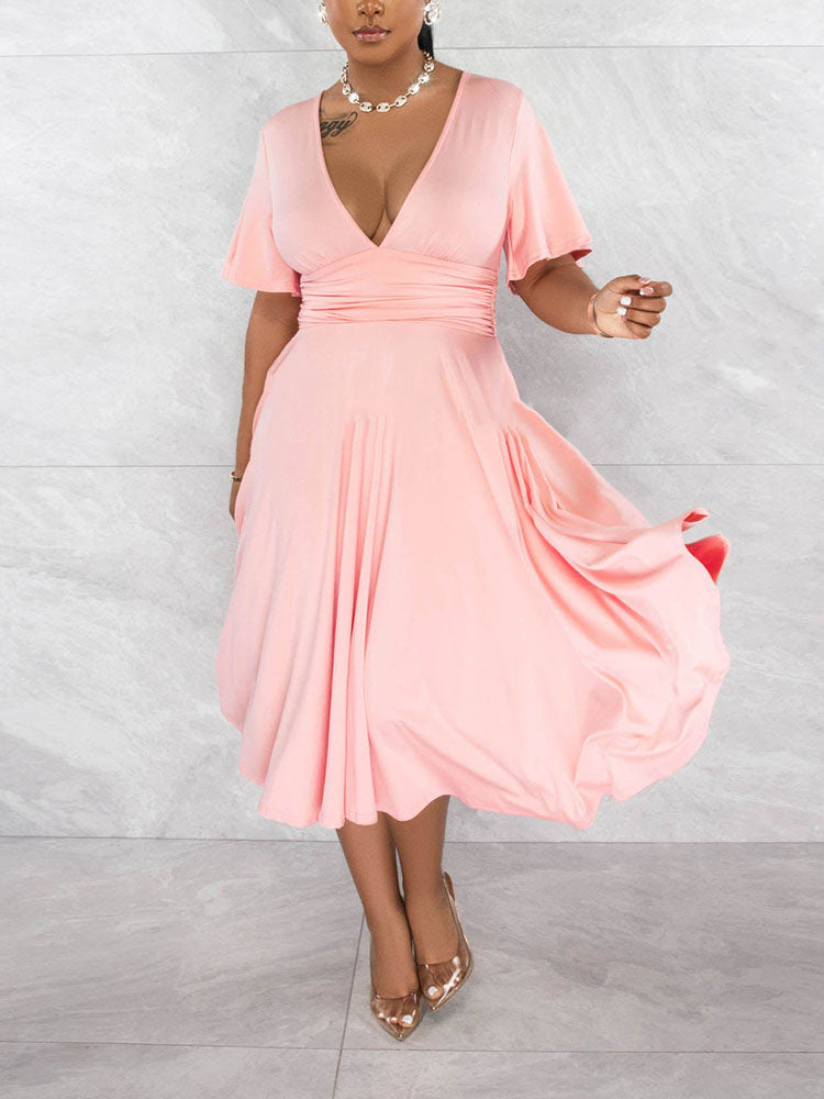 Woman wearing a light pink midi dress with a V-neck and flutter sleeves
