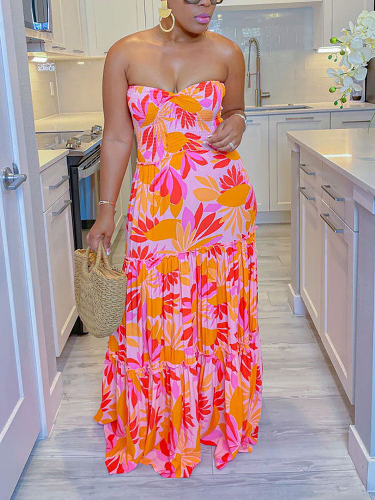 Woman wearing a pink and orange floral print strapless maxi dress