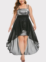 Plus-size model wearing a black and silver sequined high-low dress with a chiffon overlay.