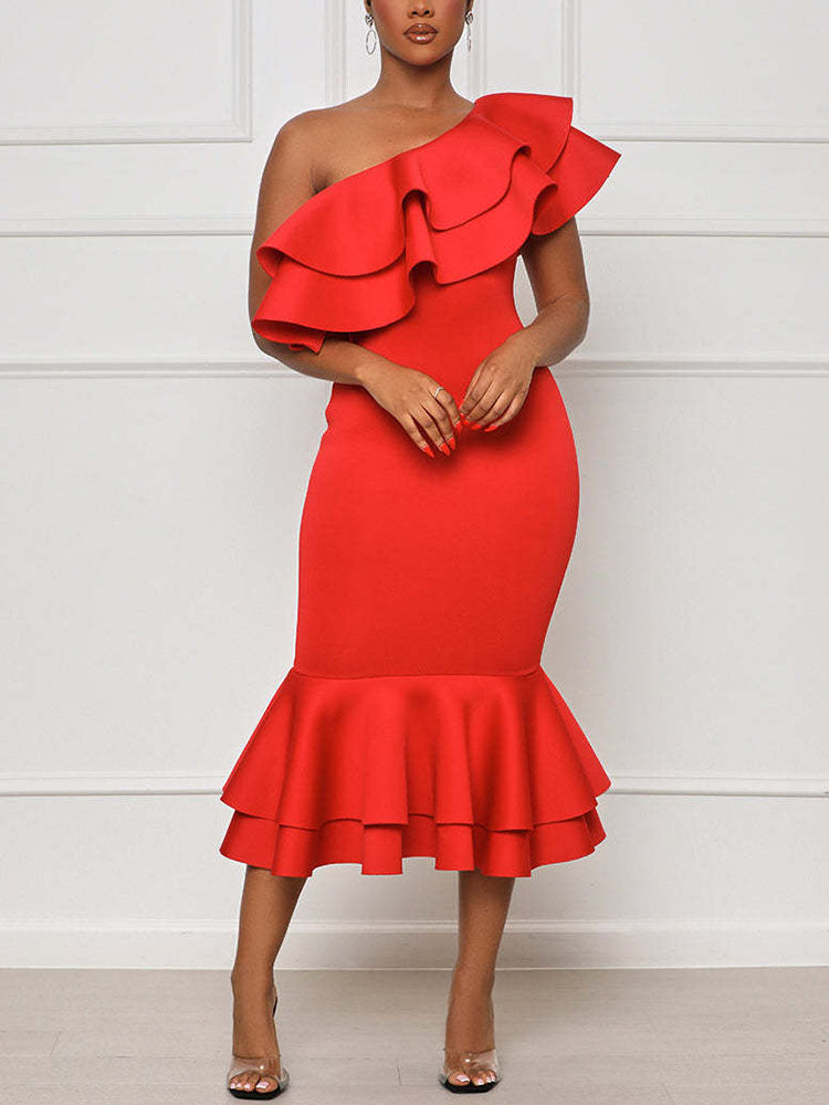Woman wearing a red one-shoulder midi dress with ruffle details and a mermaid hem.