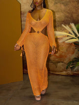 Full body shot of a woman in an orange crocheted maxi dress with cut-out details.