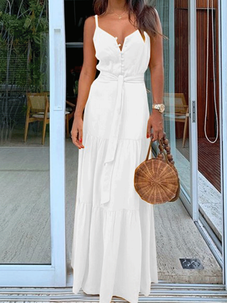 Woman wearing a white maxi dress with spaghetti straps, V-neck, button-down front, and tiered skirt.