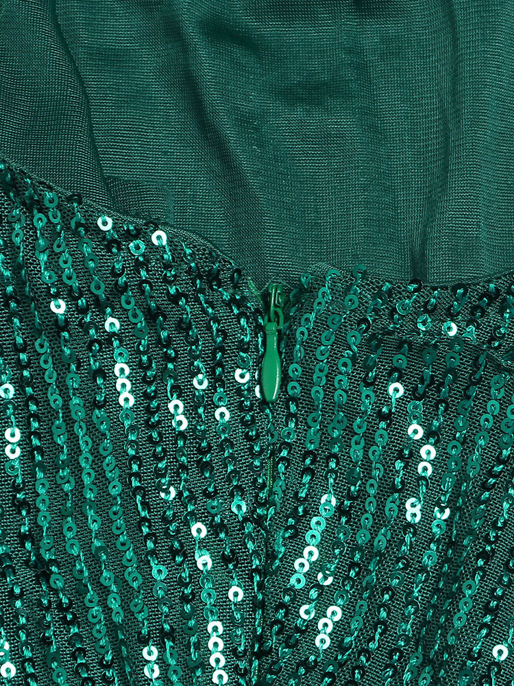 Close-up of the zipper and sequin detail on a green dress