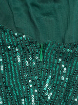 Close-up of the zipper and sequin detail on a green dress