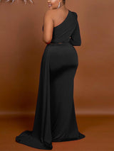 Back view of a woman wearing a black one-shoulder floor-length dress with a high slit and a draped train.