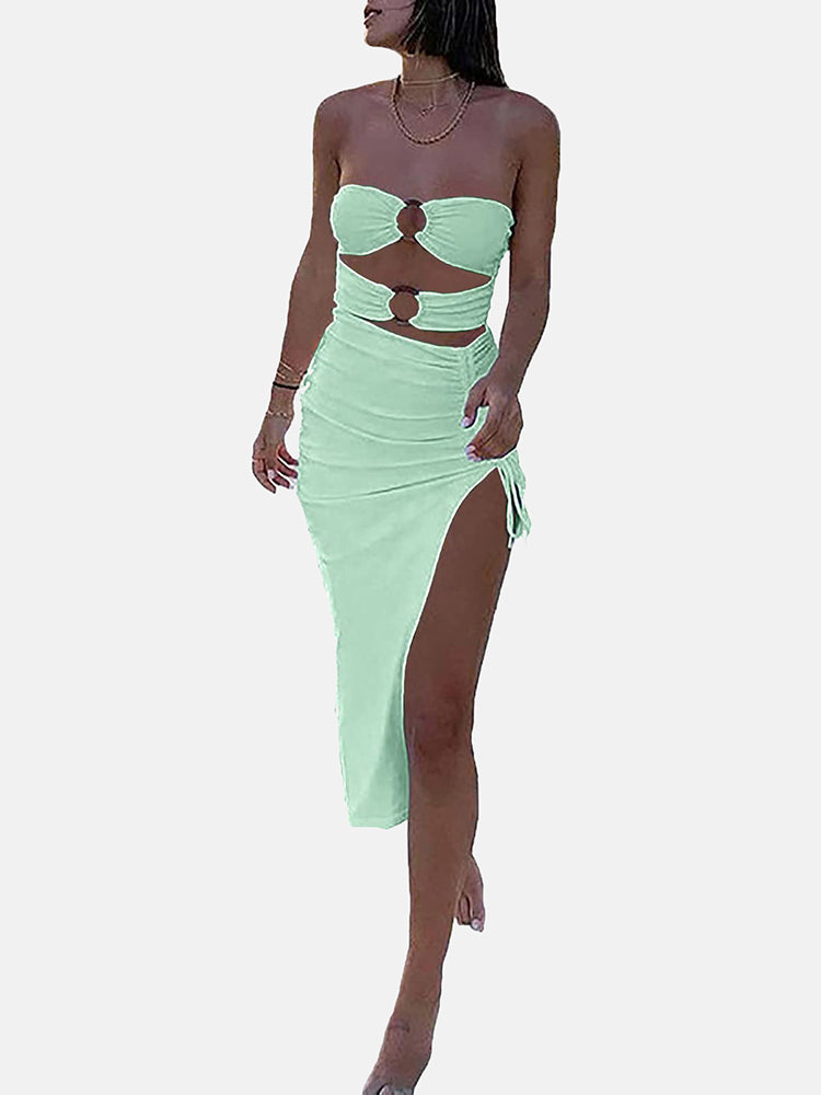 Woman in a mint green strapless two-piece set with a high slit skirt