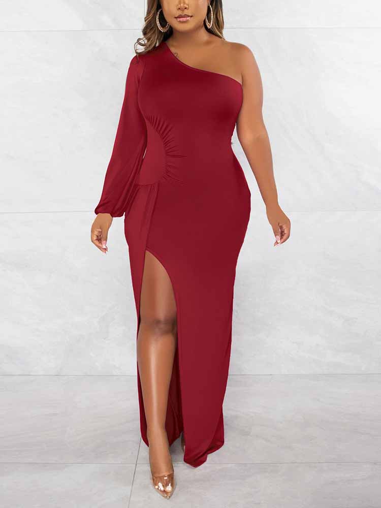 Back view of a woman in a long, red, one-shoulder dress with a high slit.