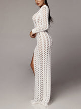 Side view of a model wearing a white one-shoulder crocheted maxi dress with a high slit and belted waist.