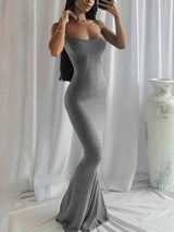 Woman in a grey spaghetti strap maxi dress