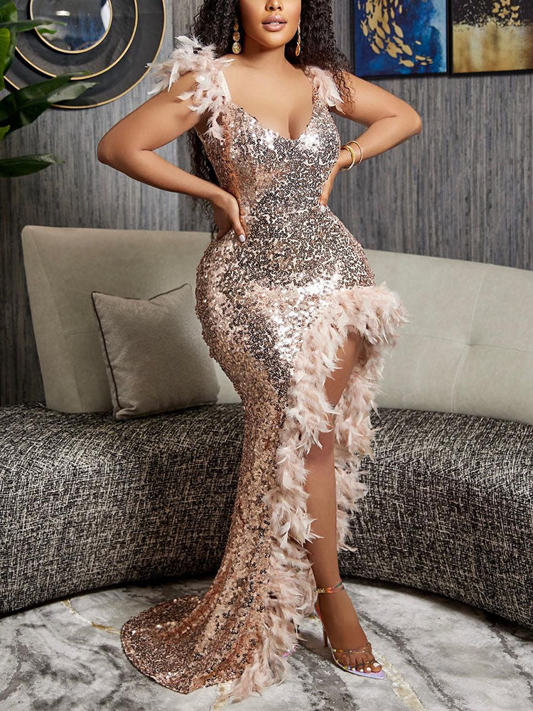 Woman in a rose gold sequin and feather gown with an asymmetrical hemline, showcasing the front view.