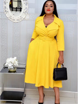 Woman in a yellow fit and flare dress with pockets, belted waist, and lapel collar.