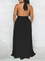 Woman wearing a black halter neck maxi dress with a keyhole cutout and pleated skirt, back view.