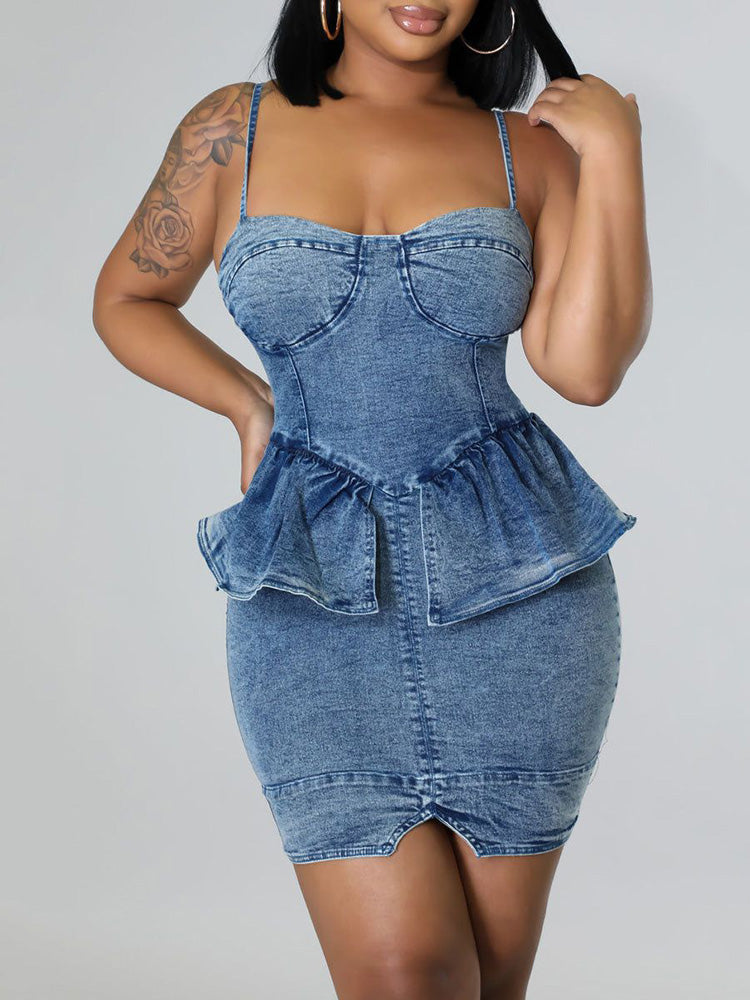 Woman wearing a blue denim dress with spaghetti straps and a peplum waist.
