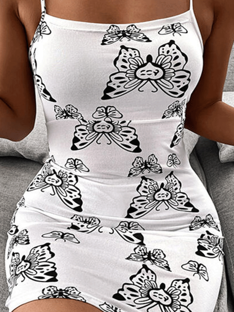 Woman wearing a white bodycon dress with a black butterfly print.