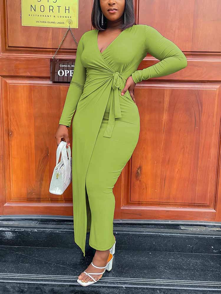 woman wearing a long-sleeved lime green wrap dress with a tie waist and side slit