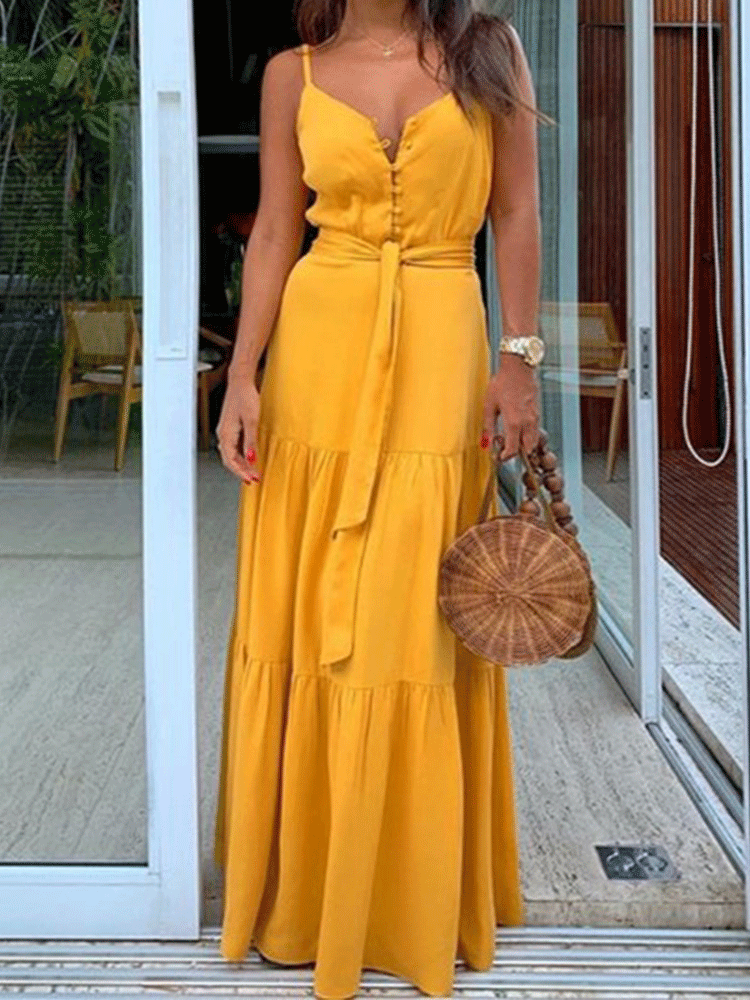 Woman wearing a yellow maxi dress with spaghetti straps, V-neck, button-down front, and tiered skirt.