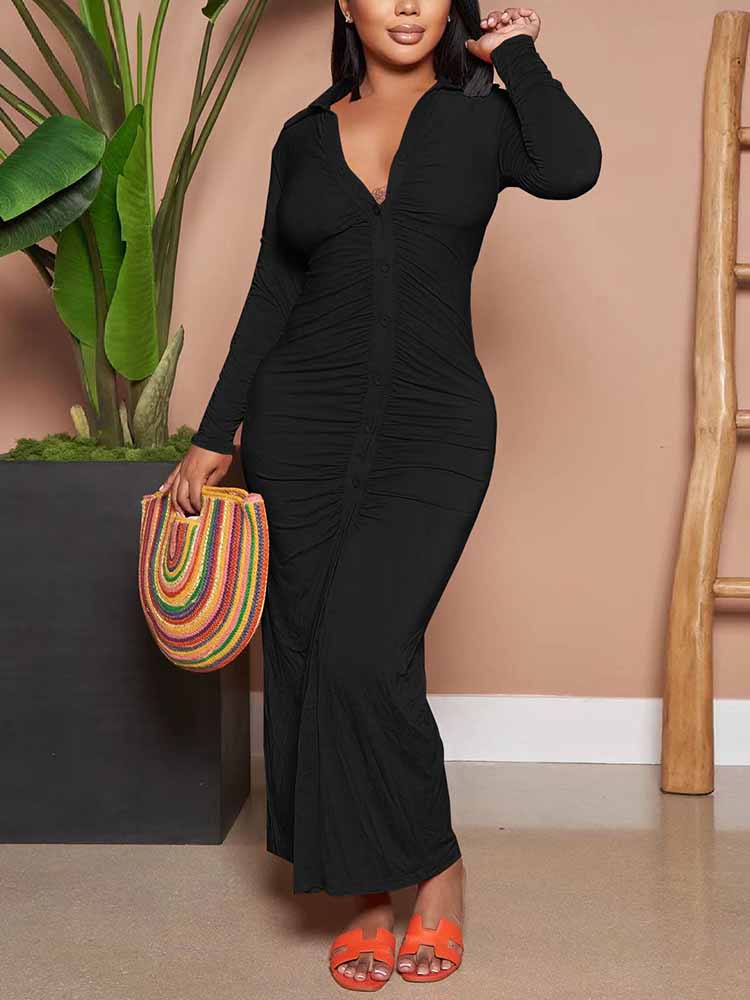 Woman wearing a black ruched maxi dress with a collared v-neck and long sleeves, holding a colorful woven bag.