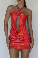 Close-up of a blue abstract print halter mini dress with ruched detailing.