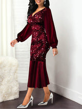Woman in a red sequined midi dress with long puff sleeves, shown from the side.