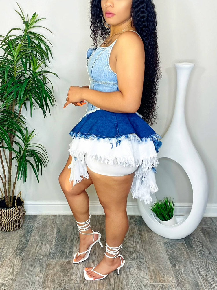 Side view of a woman in a denim romper with a tiered, distressed hem.