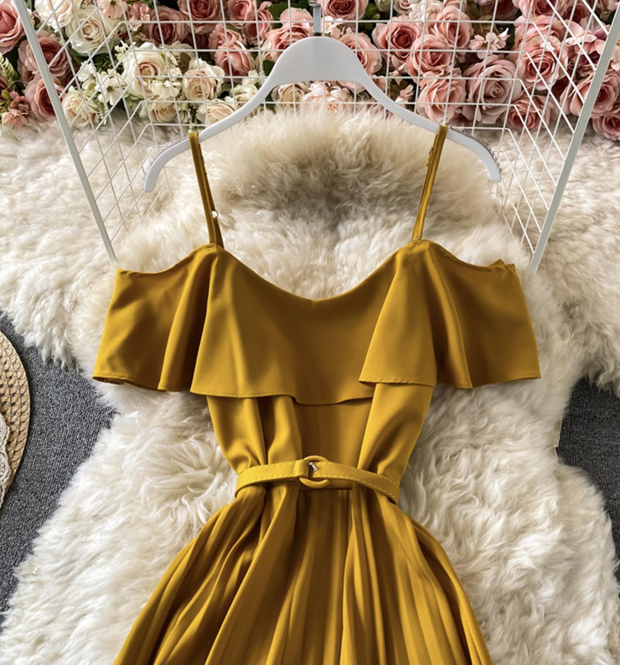 Close-up of the ruffled neckline and belt on a yellow dress